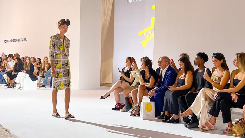 Image of students at Milan Fashion Week runway show.